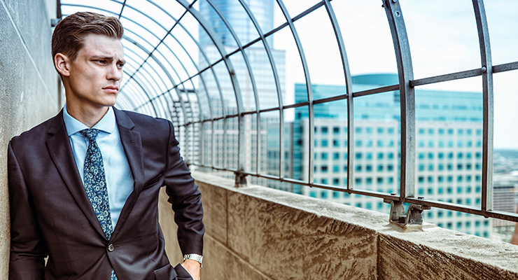 business-owner-standing-against-wall